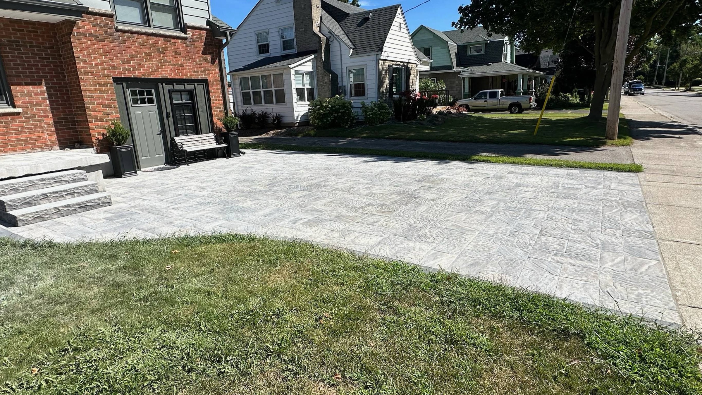 Paved patio beside a brick house